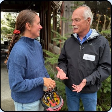 Jack McClintock speaking with a resident at a community event